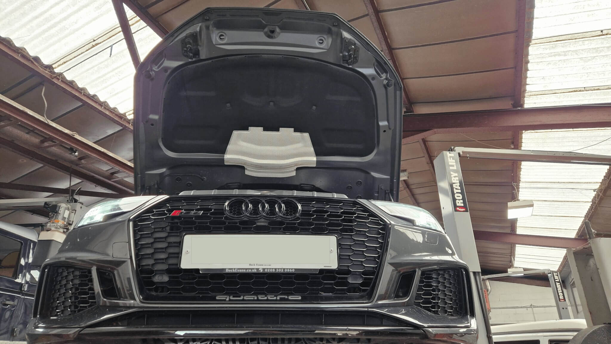 Grey Audi with bonnet open front view