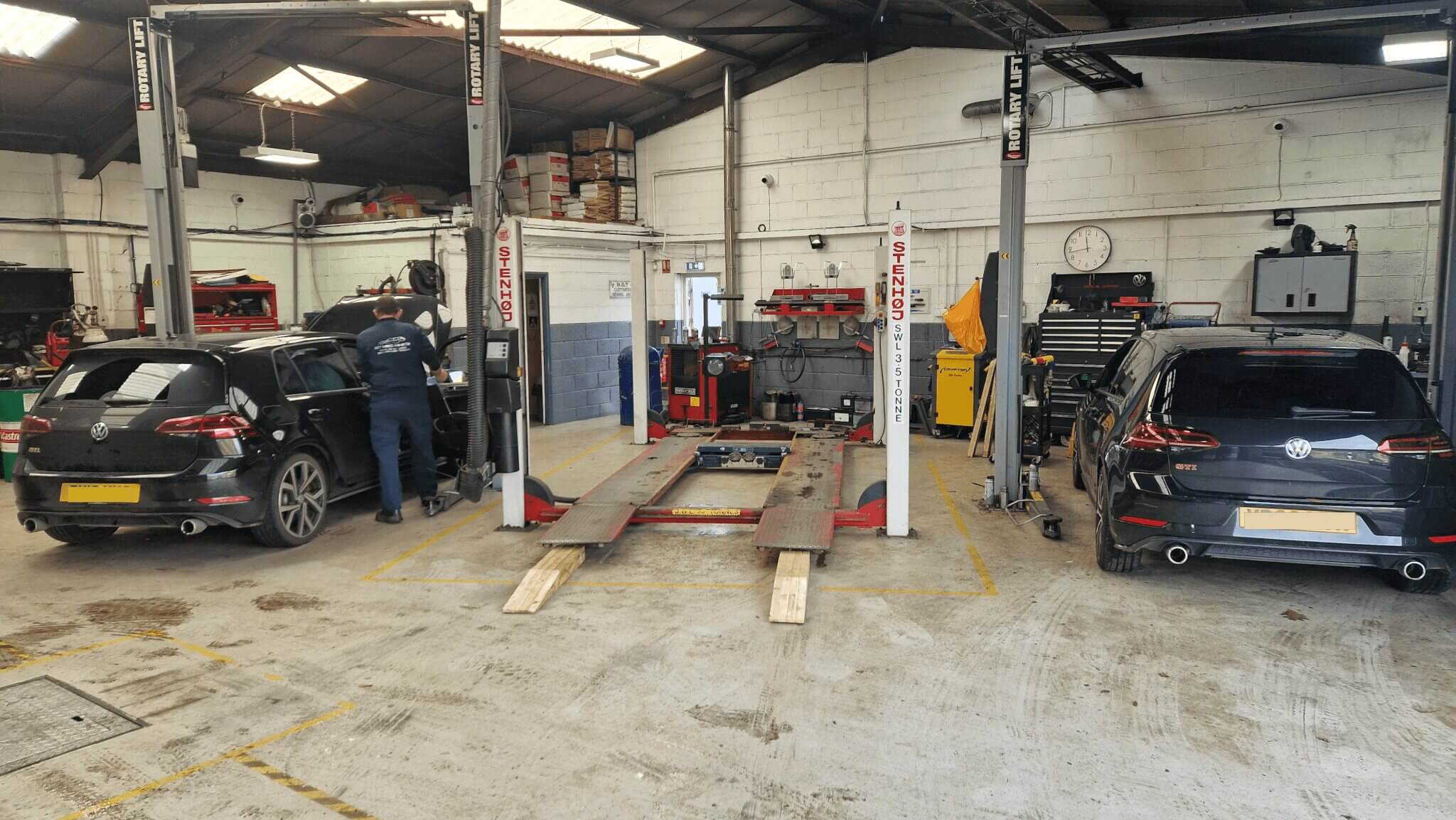 2 VW golfs being worked on in the garage